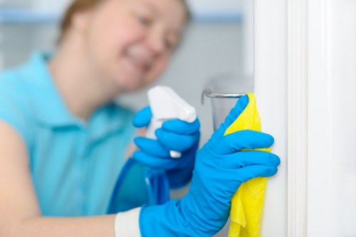 Carpet cleaning technician preparing equipment with safety measures in place
